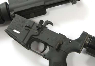 A pre-ban Colt AR-15 Sporter Lightweight rifle with upper and lower receivers separated