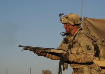 A California Army National Guard soldier firing a Mossberg 500 shotgun during a training exercise