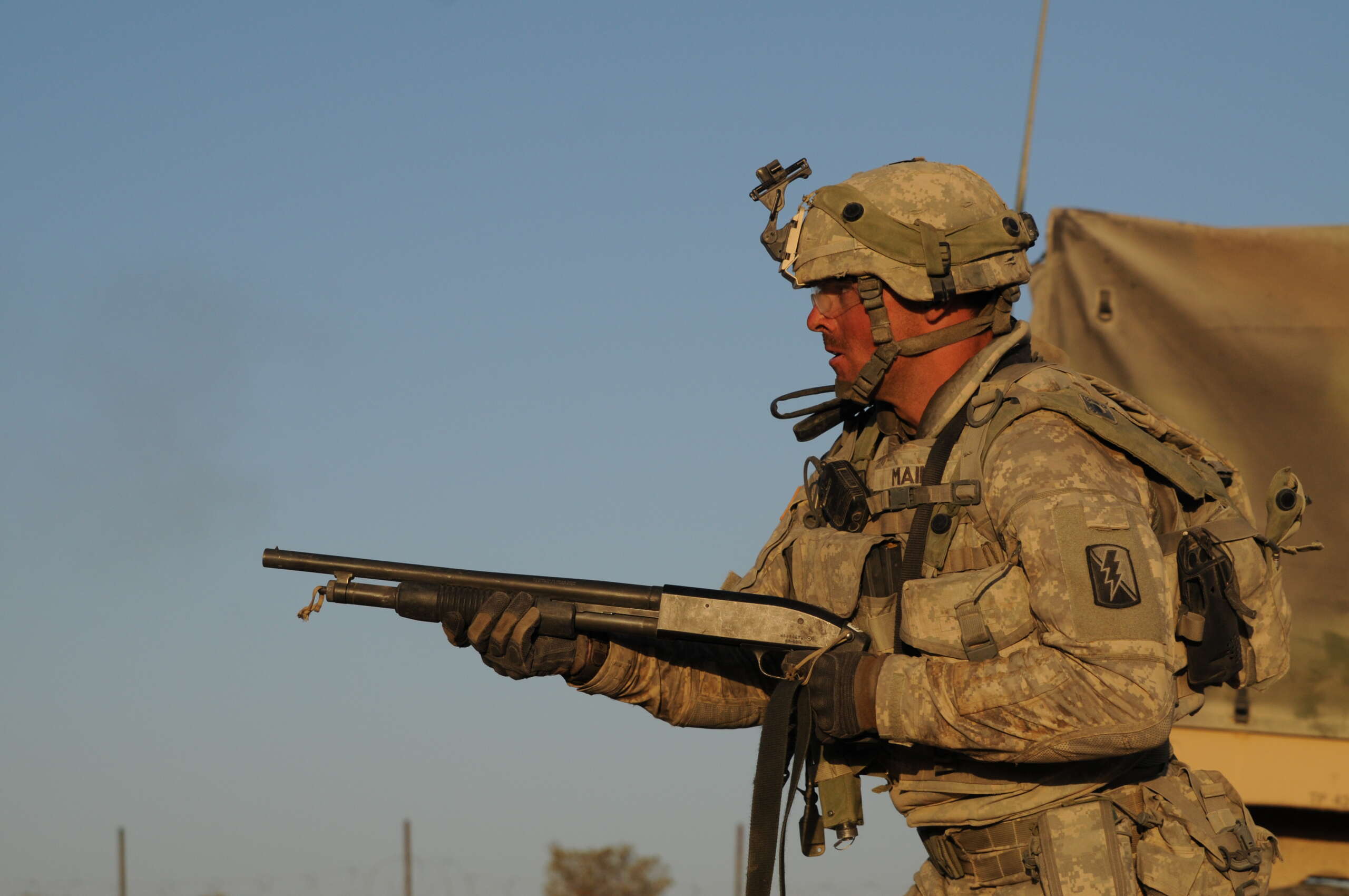 A California Army National Guard soldier firing a Mossberg 500 shotgun during a training exercise