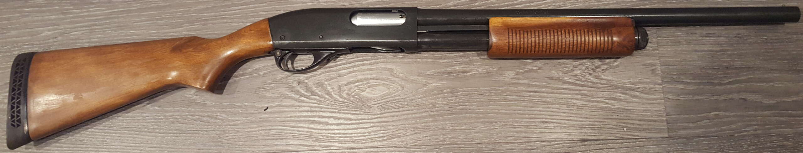 A wood-stocked Remington 870 Wingmaster pump shotgun