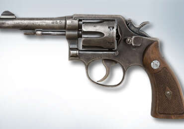 A Smith & Wesson Model 10 revolver with its cylinder open