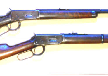 Two blued Winchester Model 1894 lever-action rifles with walnut stocks, side by side