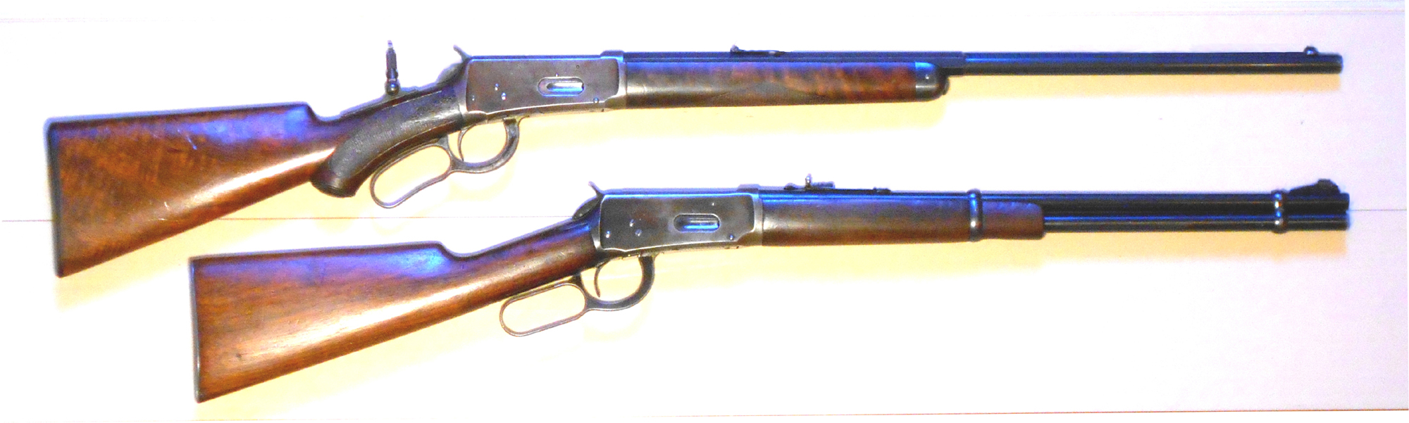 Two blued Winchester Model 1894 lever-action rifles with walnut stocks, side by side